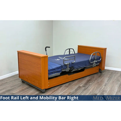 Med-Mizer ActiveCare Deluxe flat home care bed with a foot rail and a mobility assist bar on the side rails