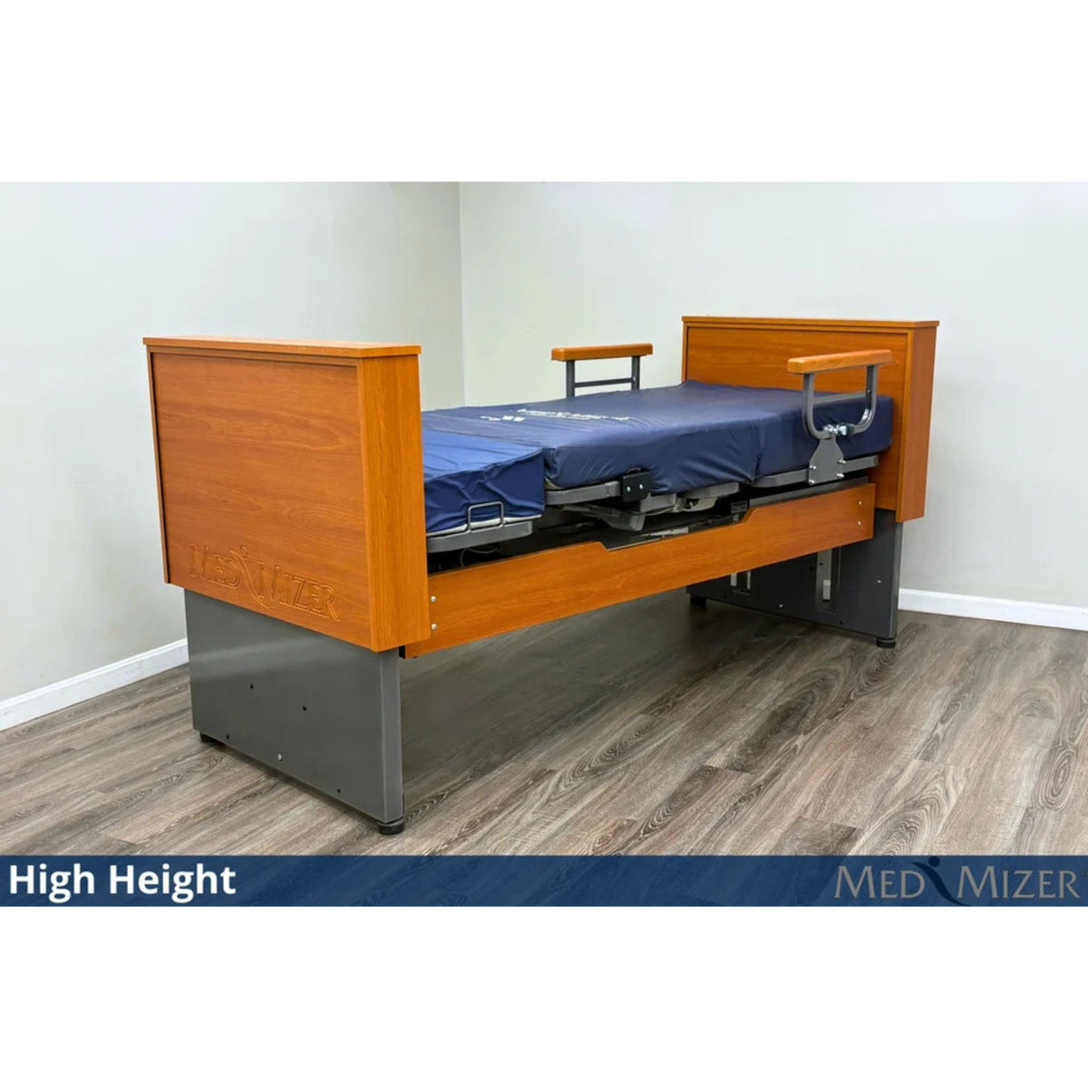 Med-Mizer ActiveCare Deluxe rotating pivot home care bed raised to full high height on a tall base with wood panels