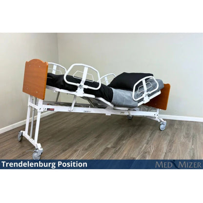 Med-Mizer ComfortWide expandable bed tilted into the Trendelenburg position with side rails and mattress