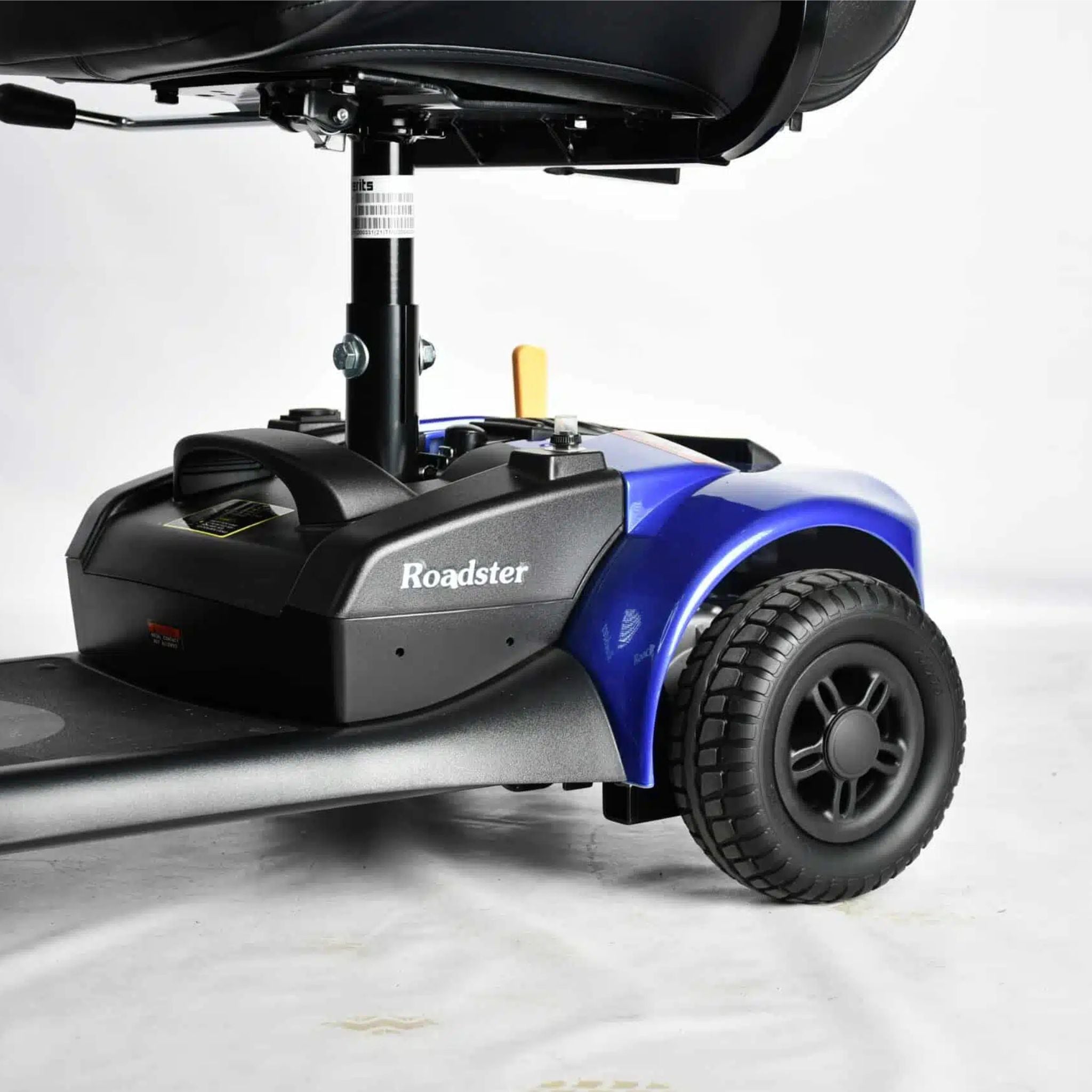 Close-up of the Merits Roadster 3 rear drive section with solid tire, battery housing, and durable wheel assembly.