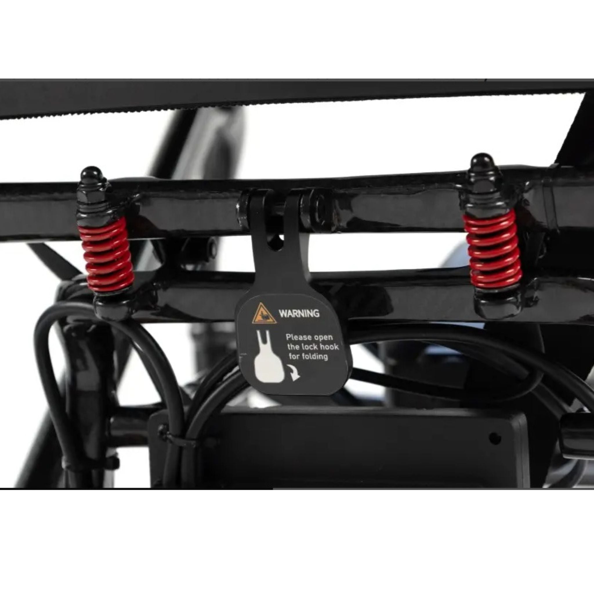 Close-up of the MM60 Carbon folding lock hook, red suspension springs, and folding warning label