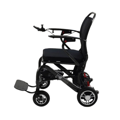 Side profile of the Monarch MM60 Carbon folding power wheelchair showing seat, joystick, and wheels