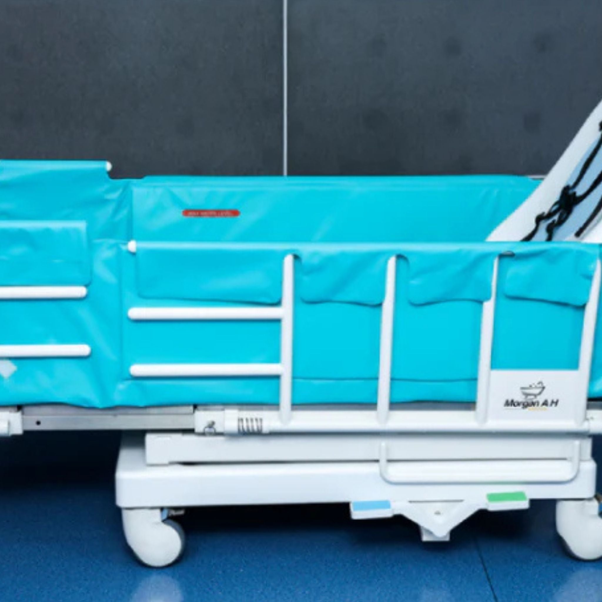 Full-length padded side panels on Morgan AH Medical shower and bathing trolley