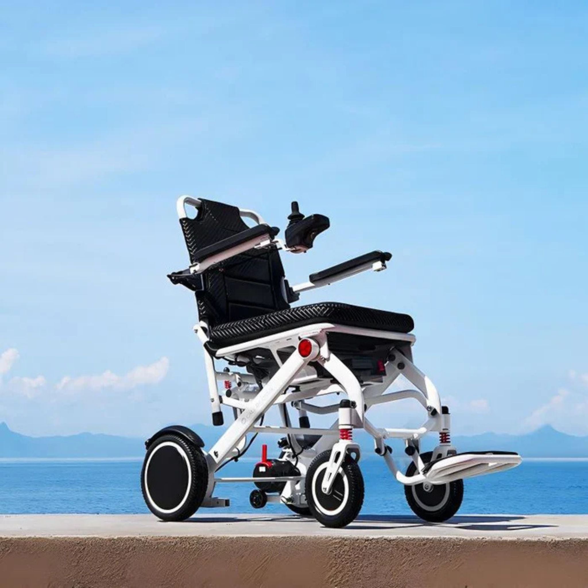 OAS Air Pro lightweight electric wheelchair parked beside the waterfront for outdoor travel