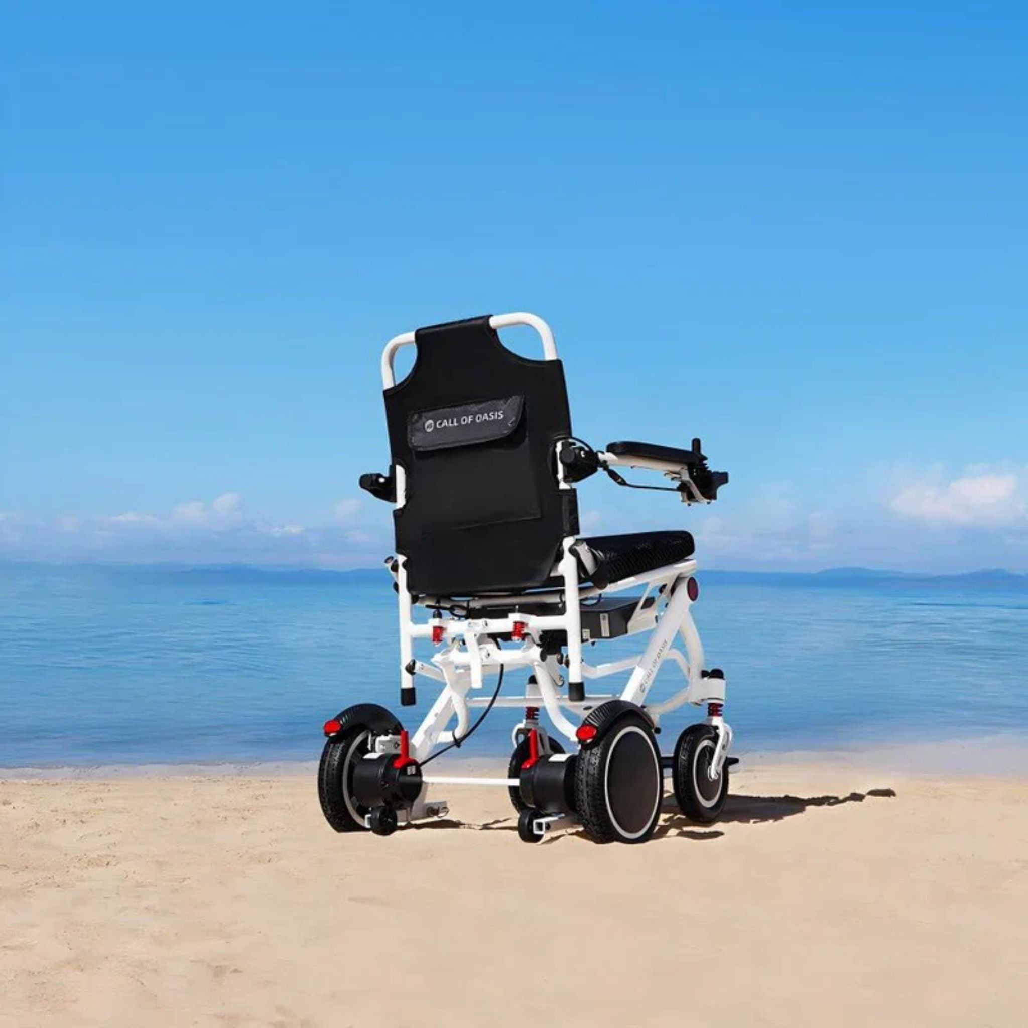 Rear view of the OAS Air Pro electric wheelchair overlooking a sandy beach and ocean