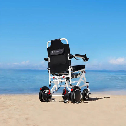 Rear view of the OAS Air Pro electric wheelchair overlooking a sandy beach and ocean