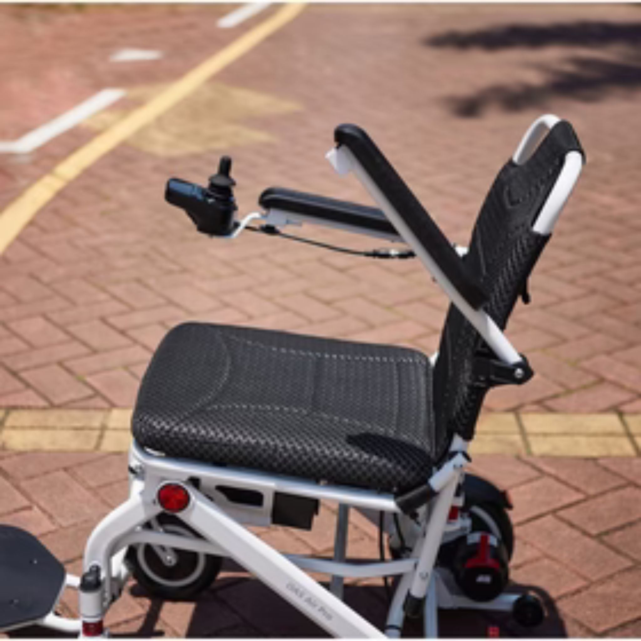 OAS Air Pro lightweight electric wheelchair featuring padded seat, backrest and adjustable armrests