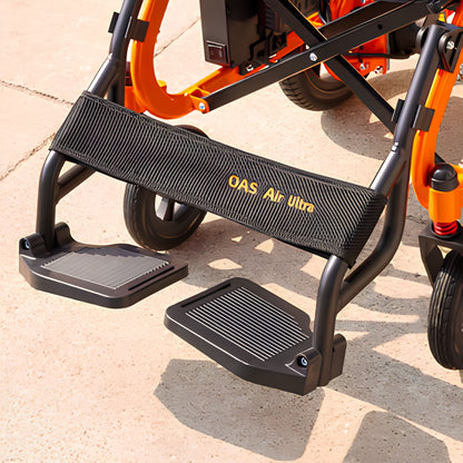 Close-up of the OAS Air Ultra orthopedic footrests and calf support strap on the orange folding wheelchair