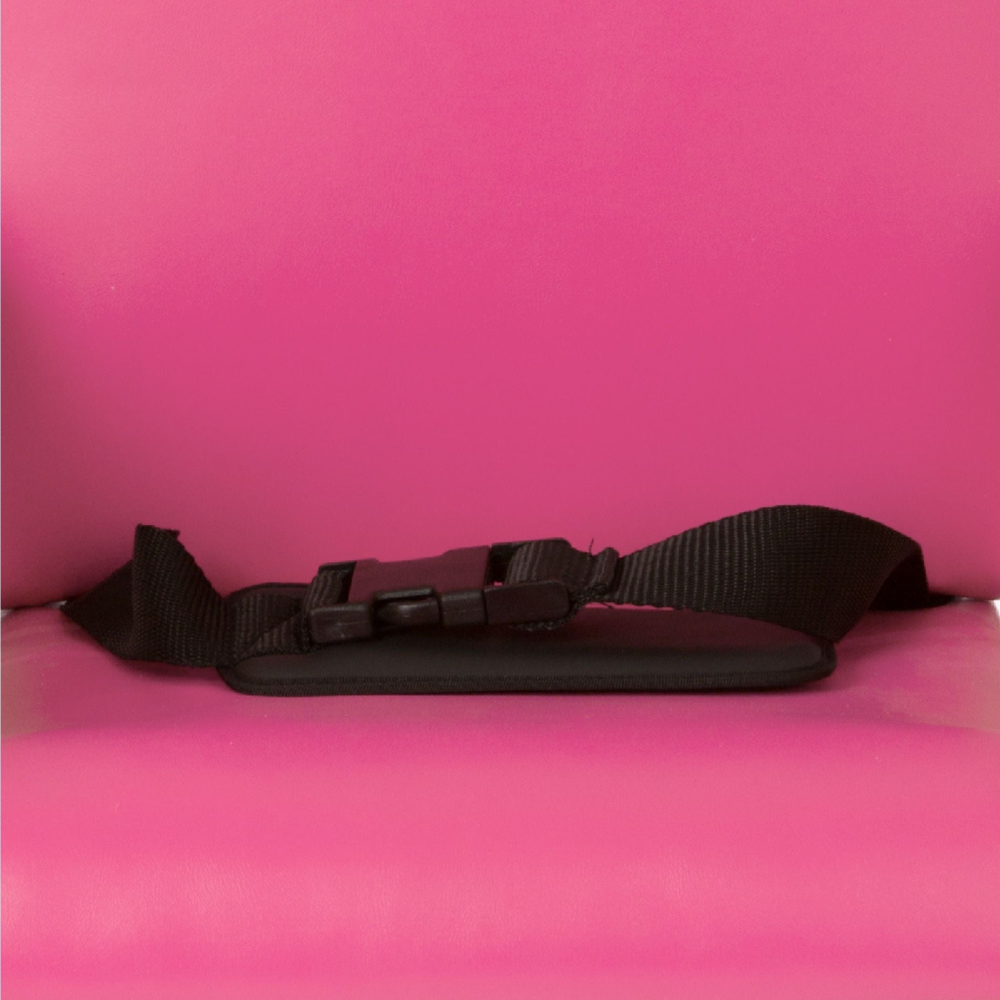 Black padded Smirthwaite Felix lap strap with push-button buckle fitted across the seat of a pink Felix school chair.