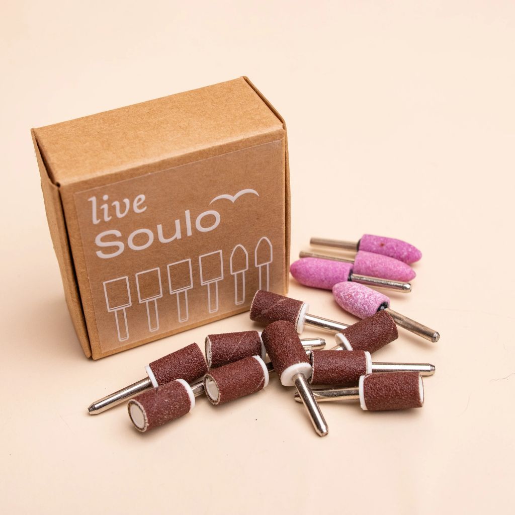 Soulo replacement tips 6-month supply with sanding bands and grinding stone tips beside a live Soulo box
