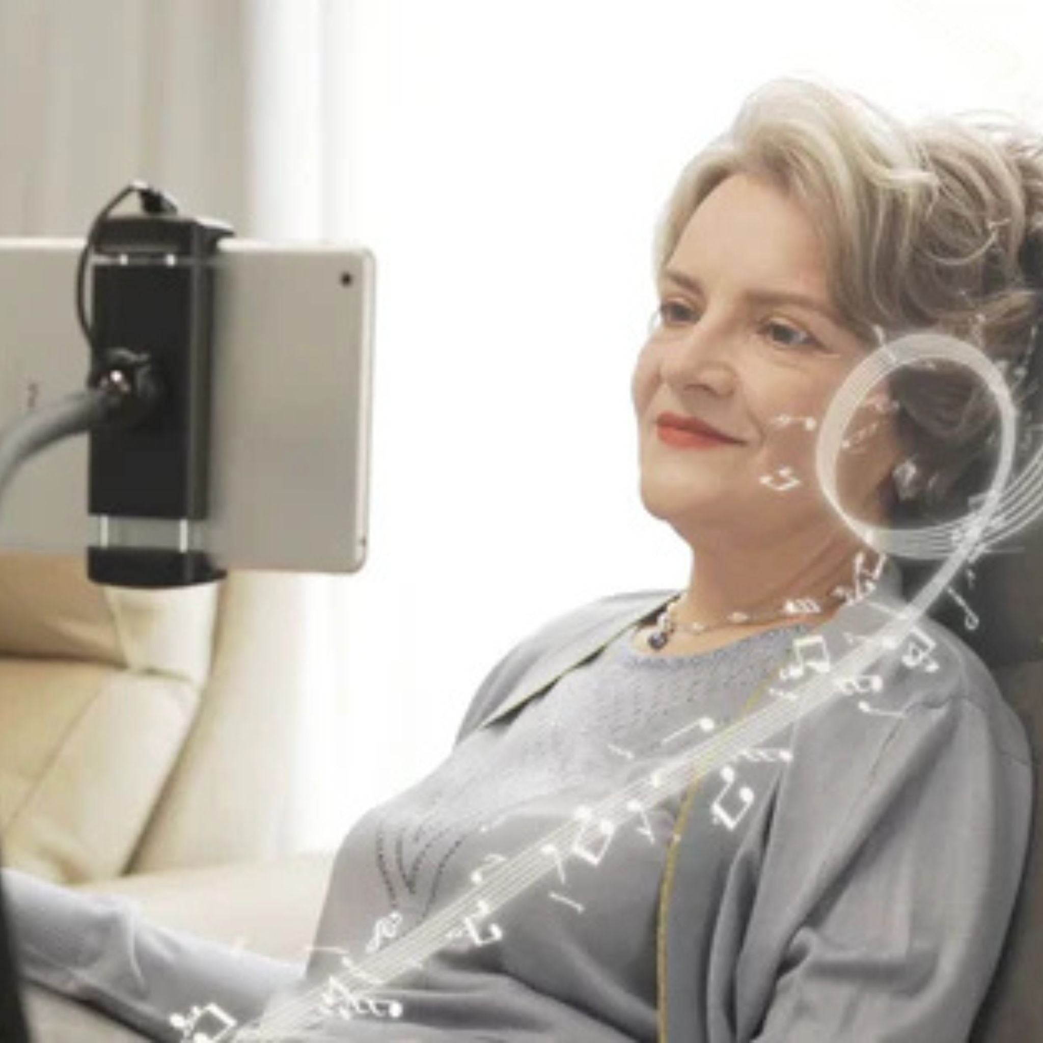 User enjoying entertainment in Starise lift recliner with mounted tablet holder for hands-free viewing convenience
