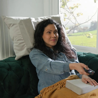 Woman watching television with Tausi Horizontal Support System providing side head support
