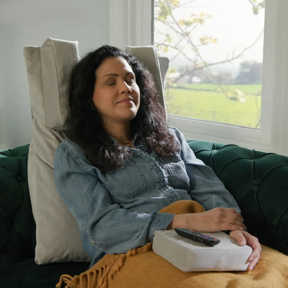 Woman seated comfortably using Tausi Vertical Support System in a recliner