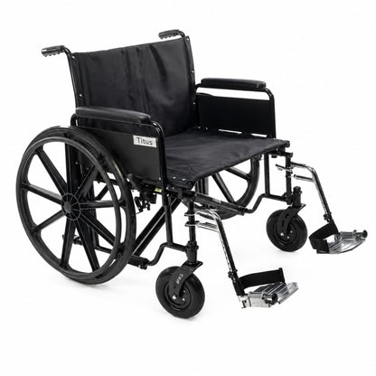 Front angle studio image of the Titus heavy-duty bariatric wheelchair featuring reinforced steel frame construction, extra-wide seating, removable arms, and durable rear wheels for high-capacity daily mobility support.