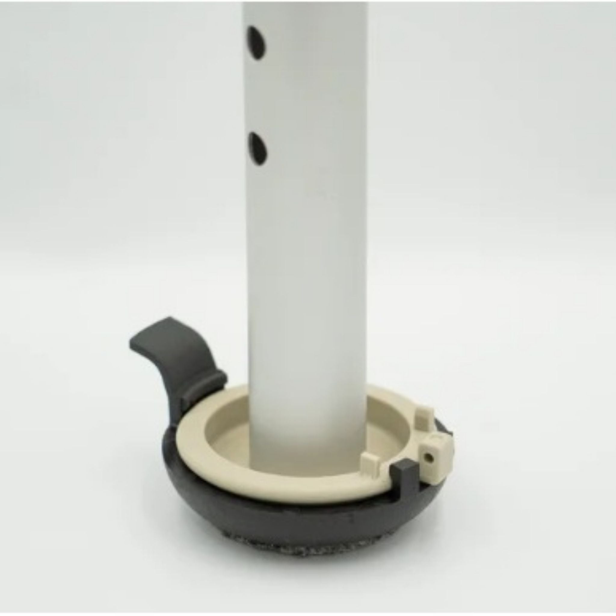 Versa Coast walker footing installed on walker leg showing removable carpeted indoor coaster and hard-surface outdoor glide for dual-use mobility.