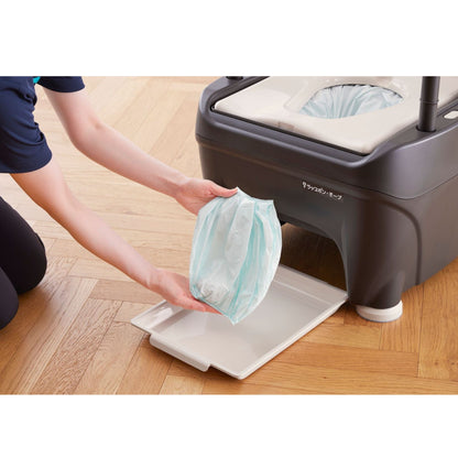 Caregiver removing sealed waste bag from the Wrappon ORB thermo-compression portable toilet system