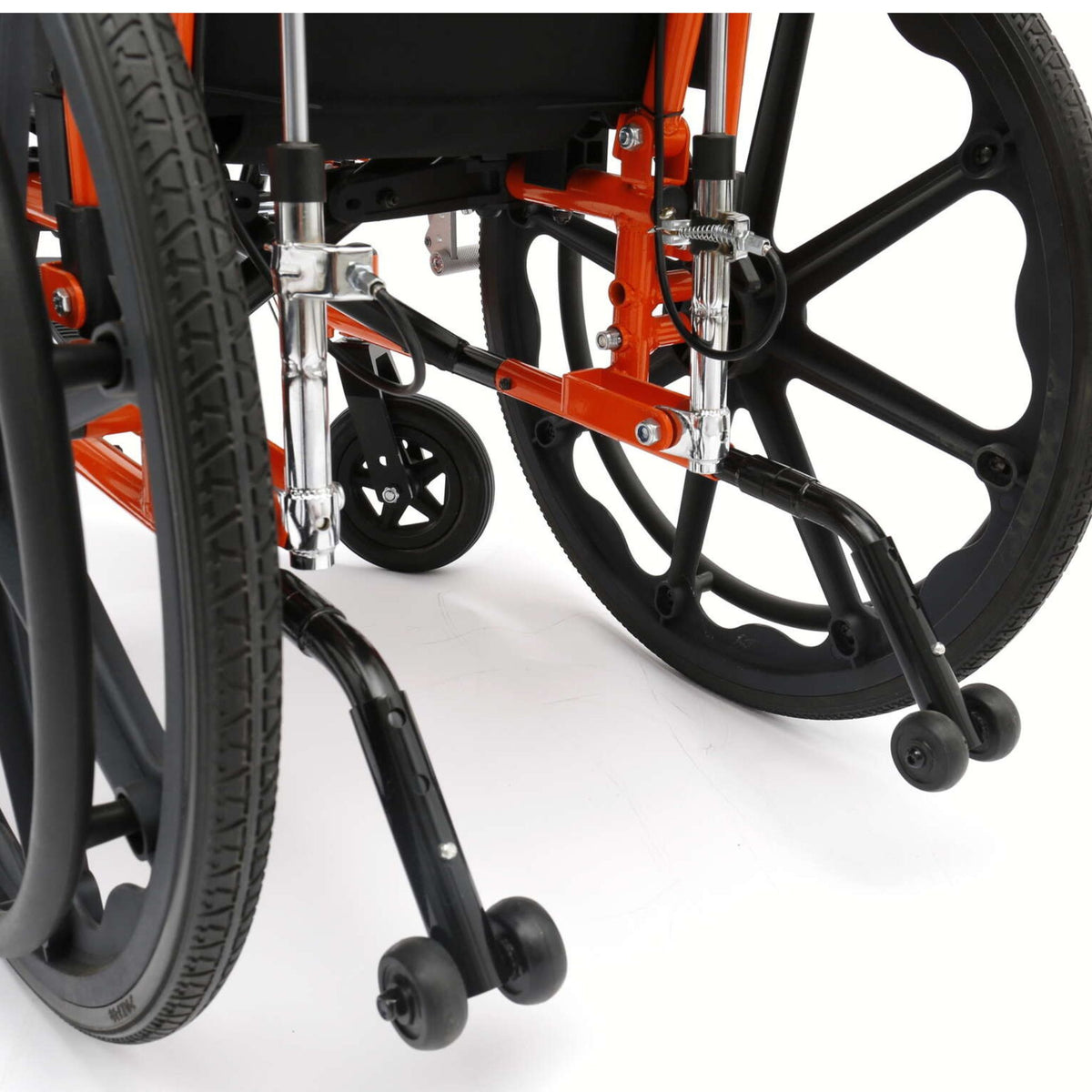 Close-up of included anti-tippers with dual wheels on the back of an orange Ziggo Pro reclining wheelchair