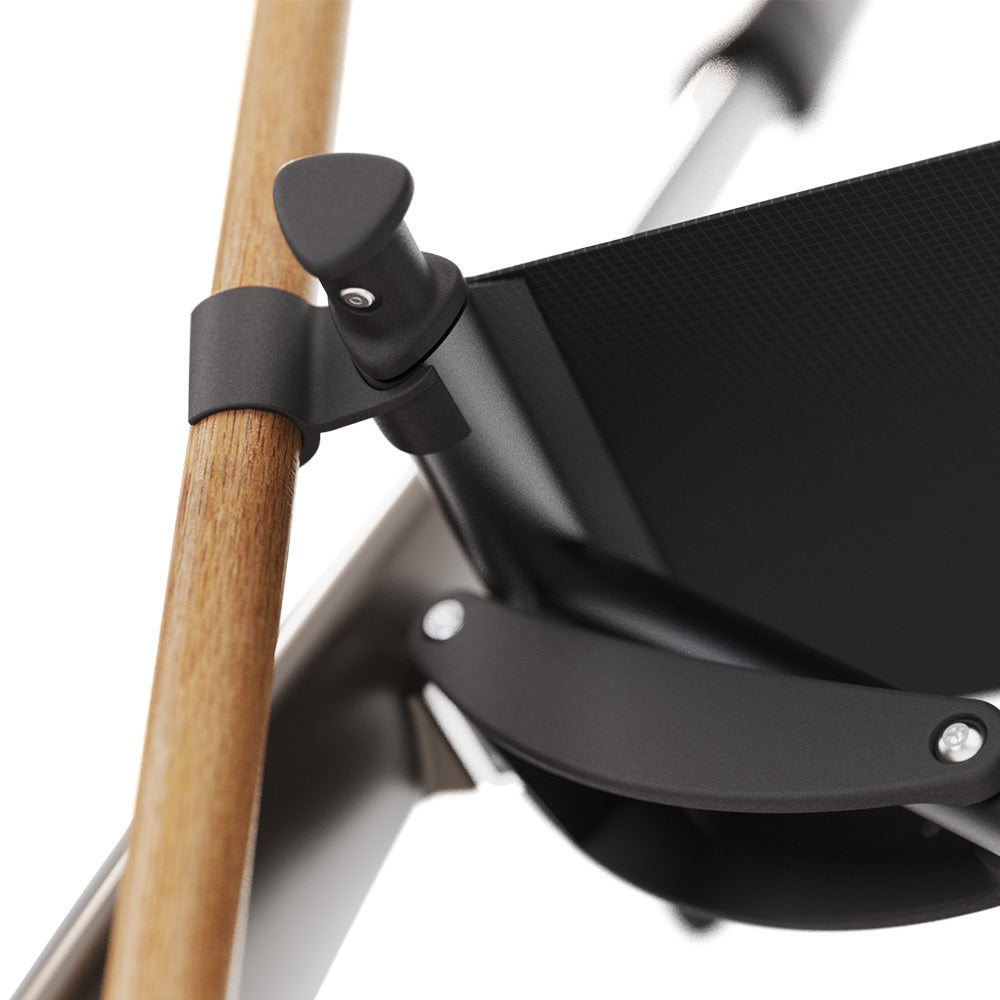 Close-up of the byACRE Carbon Overland cane holder upper clip securing a walking cane to the rollator