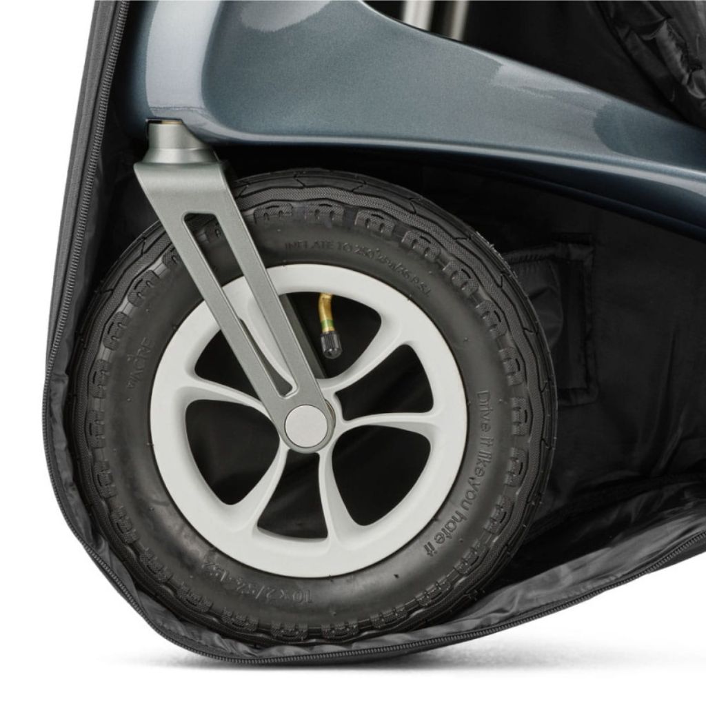 Close-up of a Carbon Overland rollator wheel and front fork inside the byACRE travel bag protection pad