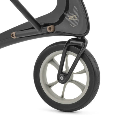 Close-up of a byACRE Carbon Ultralight puncture-proof wheel and 100% carbon composite frame badge