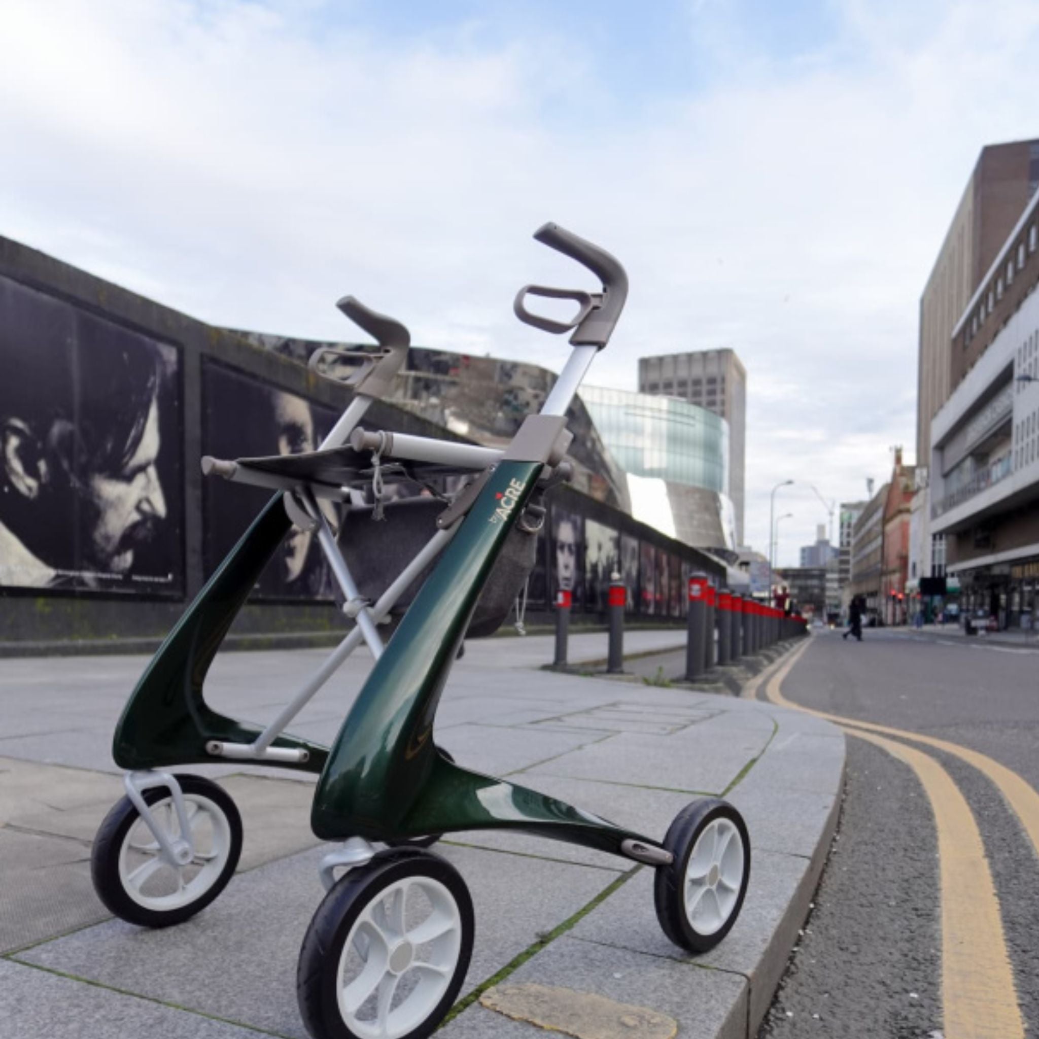 British Racing Green byACRE Carbon Ultralight rollator parked on a downtown city street