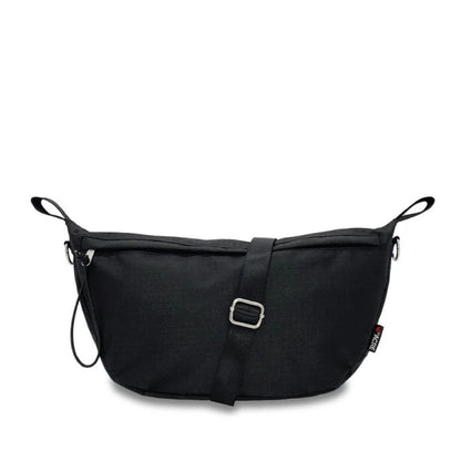 Front view of the black byACRE Pocket Bag with its adjustable shoulder strap, buckle, and zip pull