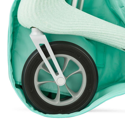 Close-up of a Nordic Pioneer front wheel and fork padded inside the Glacier Green byACRE travel bag