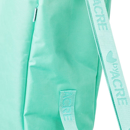 Close-up of the sturdy polyester material and the byACRE branded carry handle and shoulder strap on the travel bag