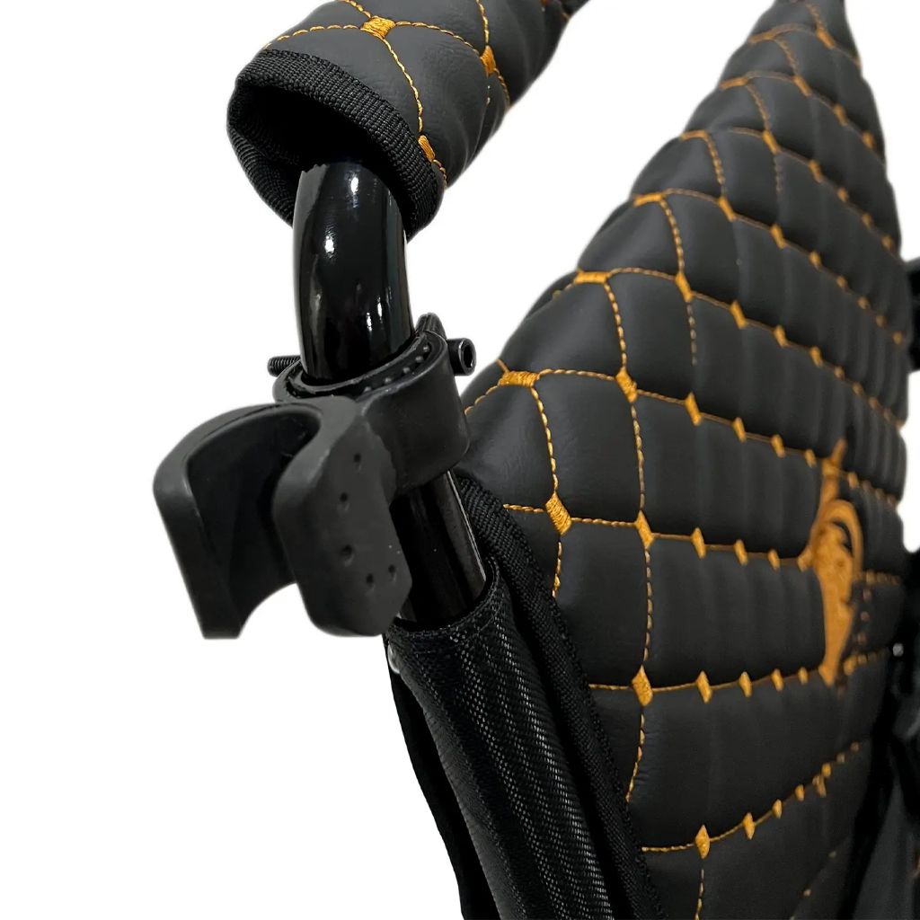 ComfyGo cane holder mounted on the backrest frame of a quilted Majestic wheelchair, ready to hold a cane