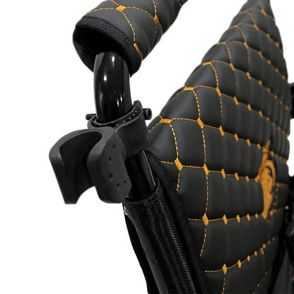 ComfyGo cane holder mounted on the backrest frame of a quilted Majestic wheelchair, ready to hold a cane