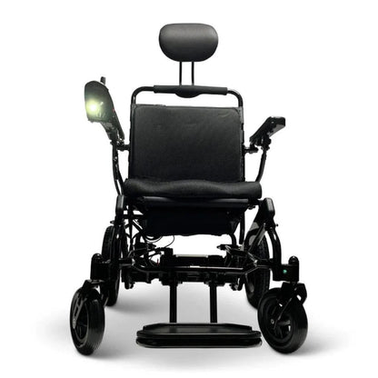 Front view of a Majestic power wheelchair with the ComfyGo headlight turned on and glowing at the armrest