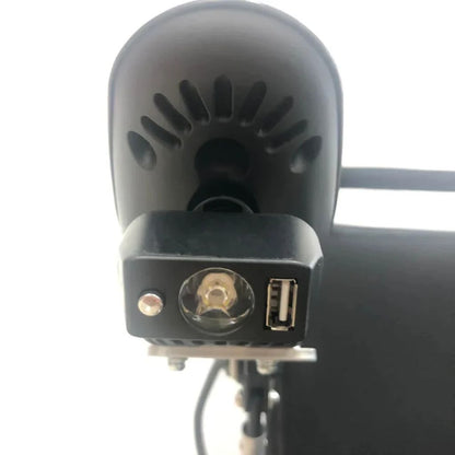 Close-up of the ComfyGo headlight face showing the LED bulb, light switch, and USB charging port