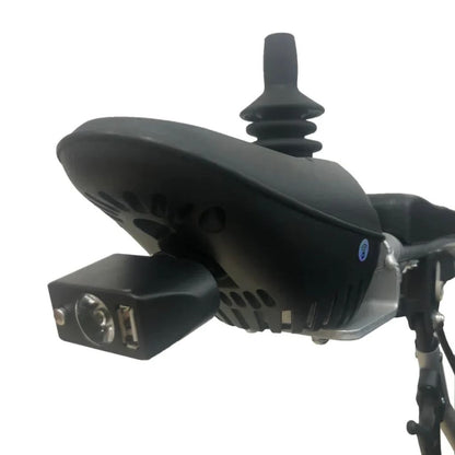 Close-up of the ComfyGo headlight with USB port mounted under the joystick controller, shown turned off