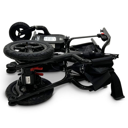 ComfyGO Phoenix Carbon electric wheelchair folded for travel and storage, showing compact carbon fiber frame, dual motor system, and lightweight portable folding design.