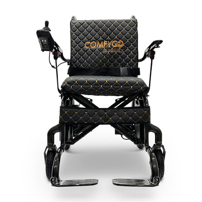 Front view of the ComfyGO Phoenix Carbon electric wheelchair with carbon fiber frame, joystick controller, quilted seating, foldable armrests, and compact portable design.