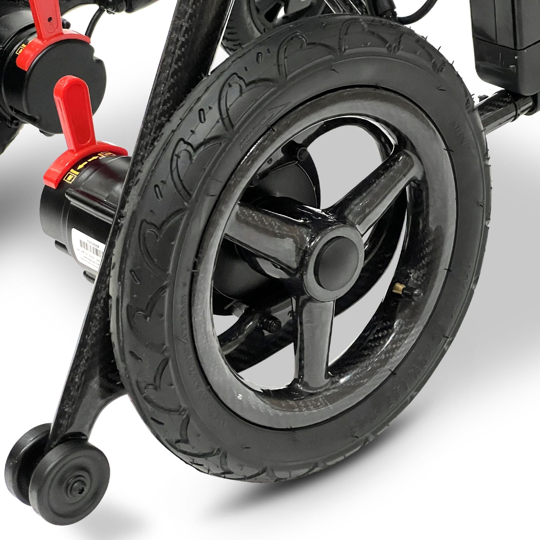 Close-up of the ComfyGO Phoenix Carbon electric wheelchair rear wheel, carbon fiber frame, and suspension system with durable treaded tire and compact folding wheelchair design.
