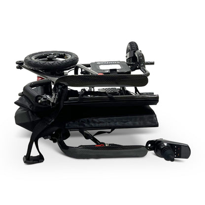Side view of the ComfyGO Phoenix Carbon electric wheelchair folded into an ultra-compact size with detachable joystick, carbon fiber frame, and portable travel-ready design.