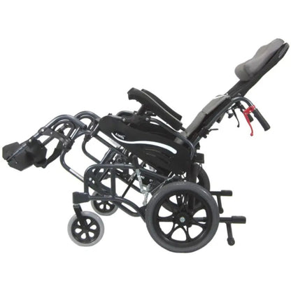 Side profile of the Karman VIP-515-TP reclining tilt-in-space wheelchair with elevated leg rests, padded headrest, and full tilt positioning on a white background
