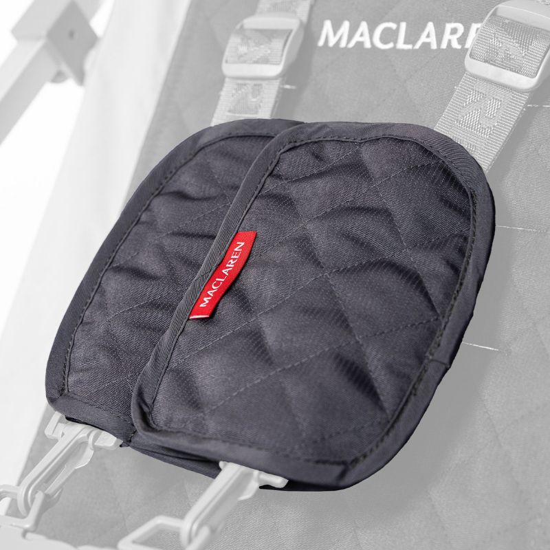 Close-up of Maclaren Major Elite quilted chest pads fitted over the shoulder straps of the five-point harness