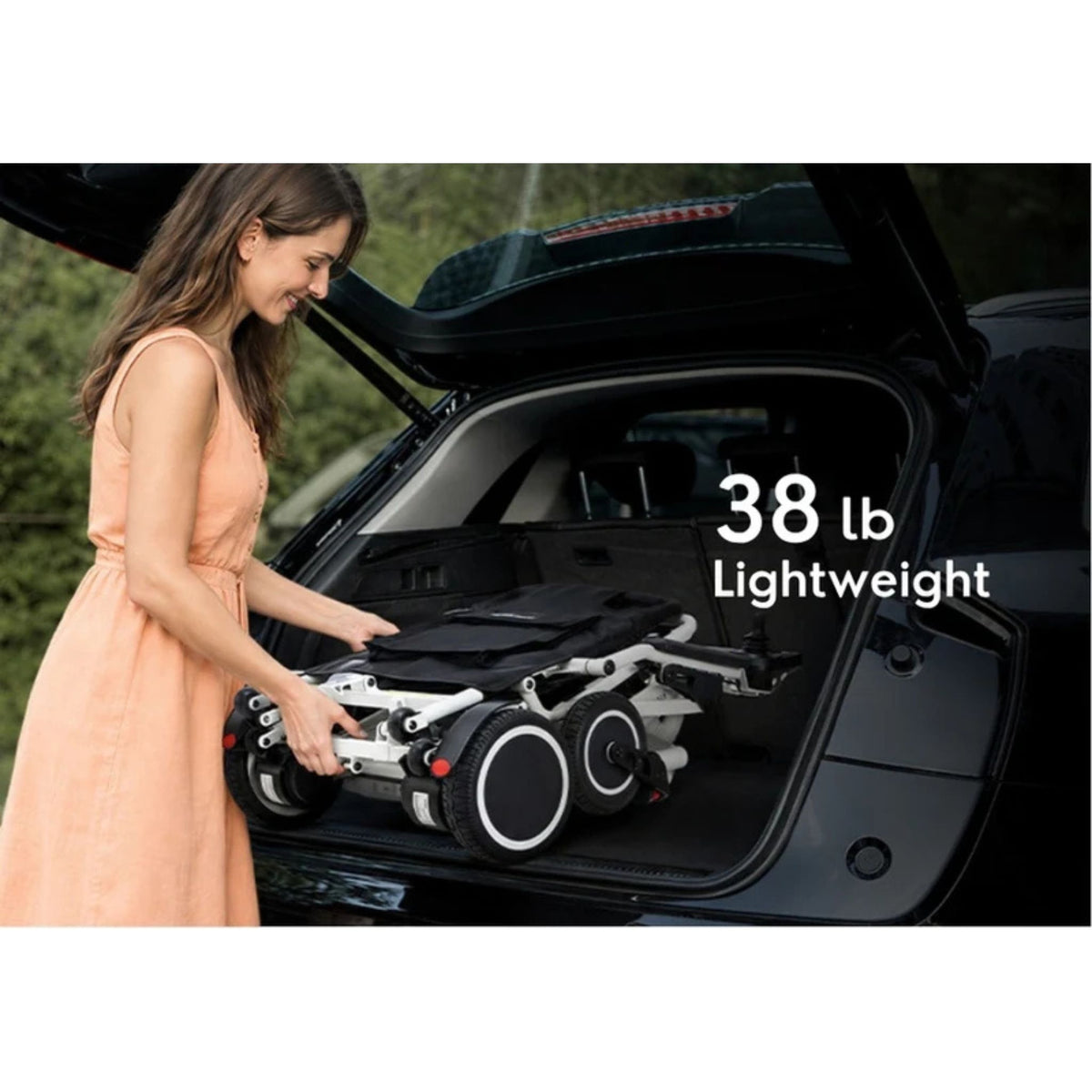 Woman lifting the 38-pound OAS Air Pro 2027 folding electric wheelchair into a car trunk