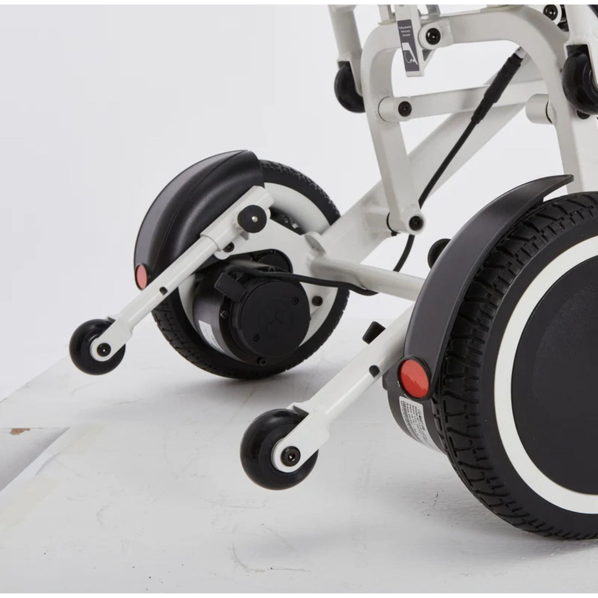 Rear view of the OAS Air Pro 2027 adjustable anti-tip wheels and 8.5-inch rear drive wheels on an incline